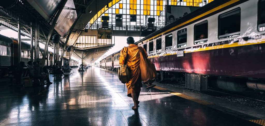 Buddhist monk boarding a train from Bangkok to Udon Thani