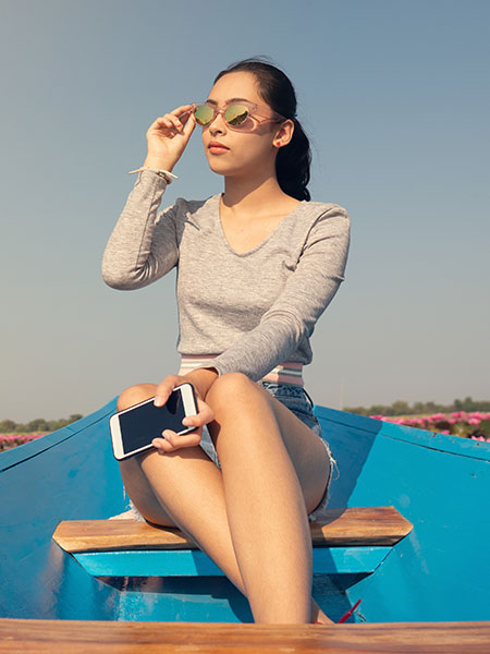 The Red Lotus Lake Udon Thani: A Young Woman in a Blue Canoe Enjoying the Sunrise Over the Lake