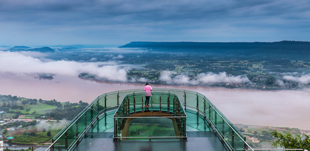 Glass skywalk over a misty Mekong River