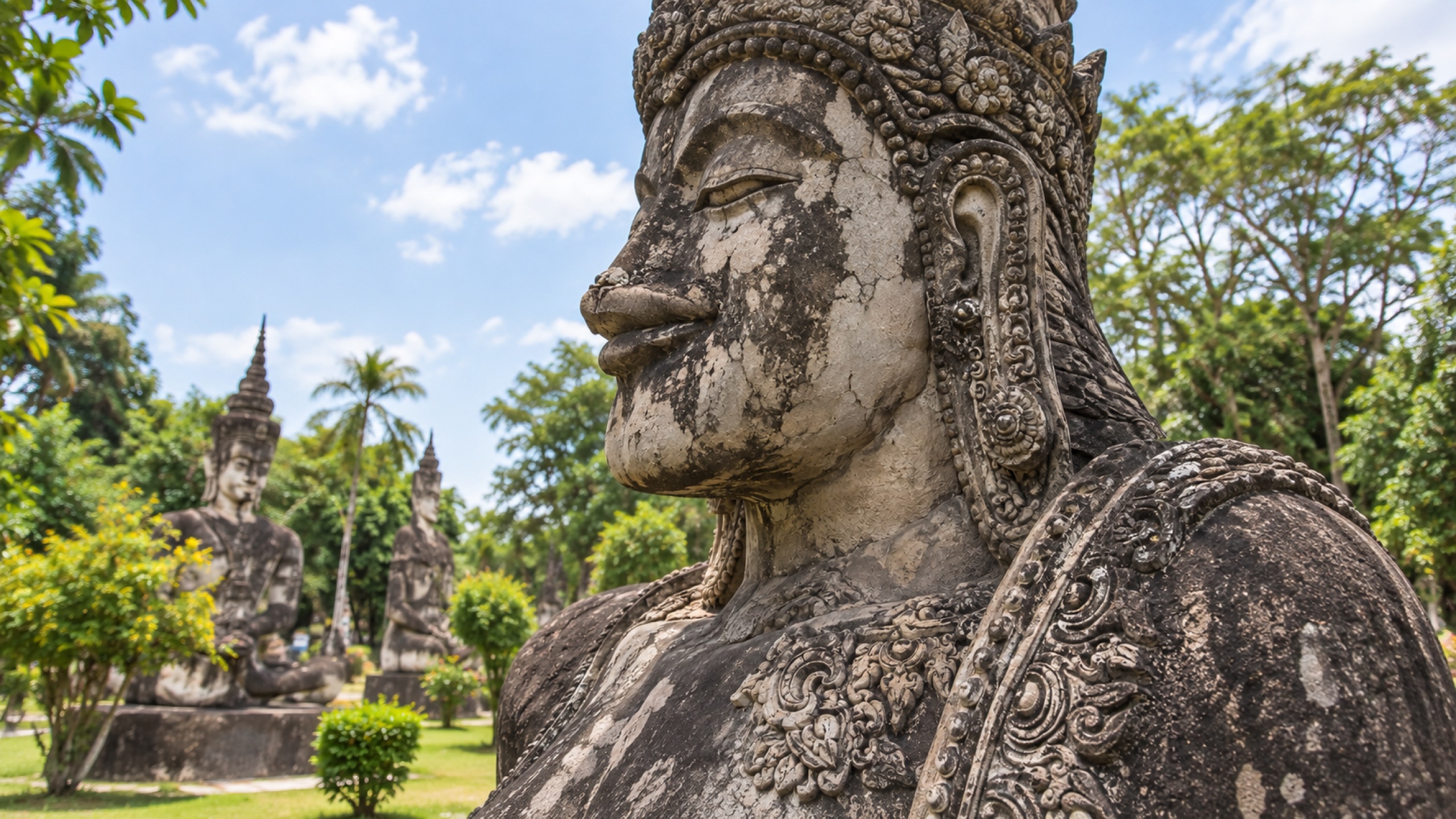 Close view of the weathered handmade concrete and intricate decoration of a Sala Keoku sculpture.