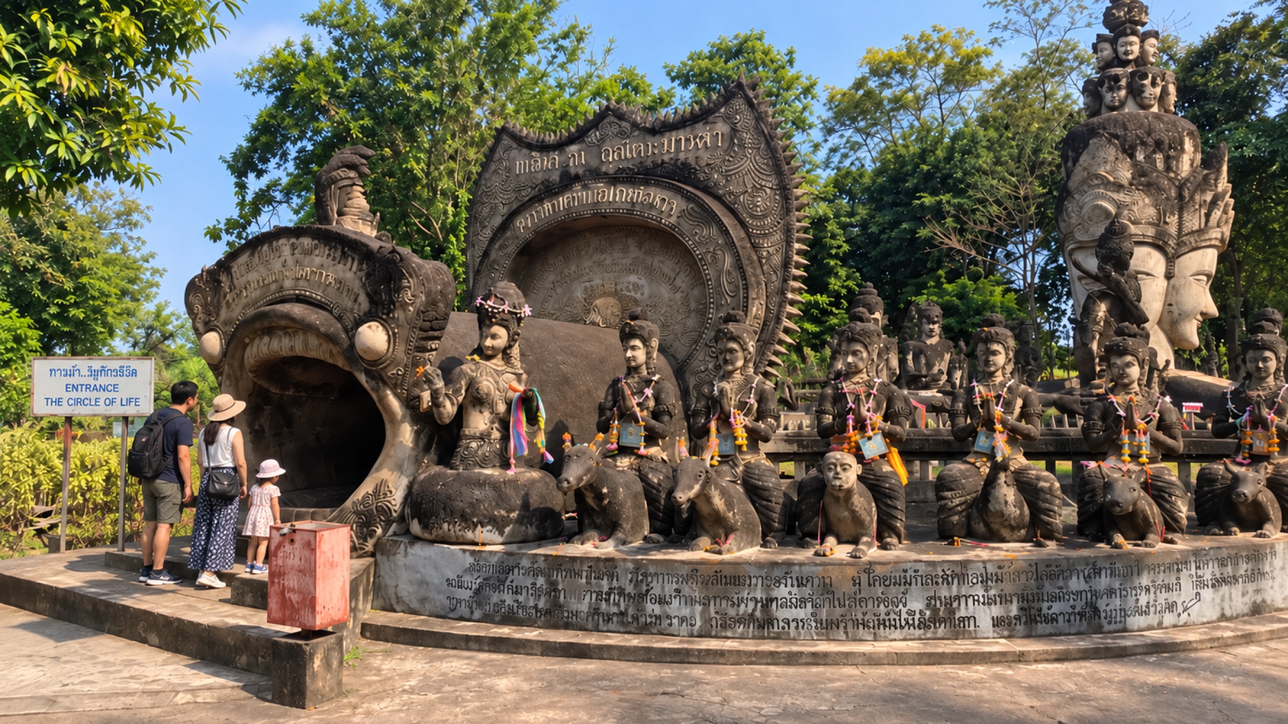 Visitors approaching the mouth-like entrance to the Circle of Life at Sala Keoku in Nong Khai.