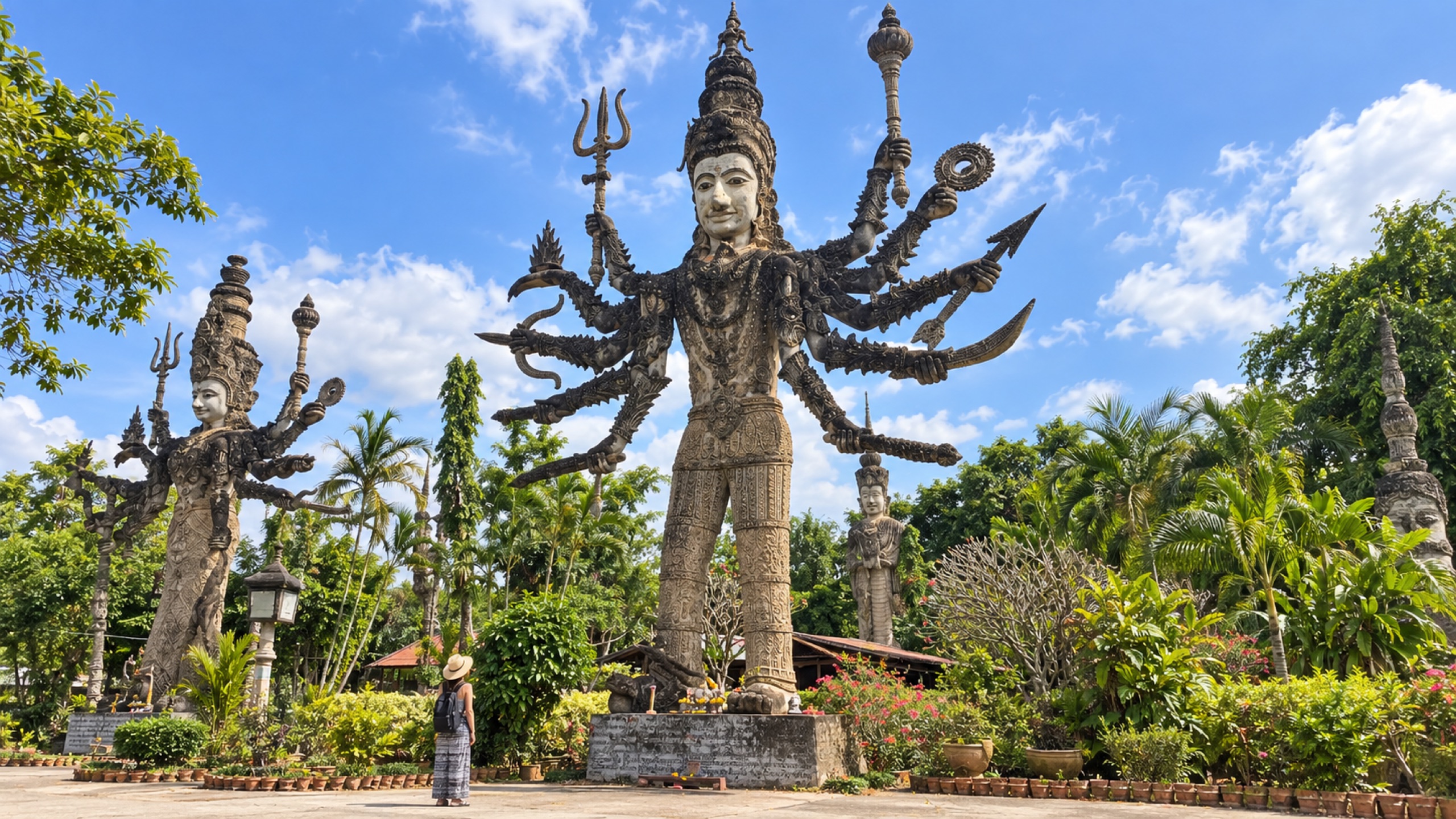 Towering multi-armed deity sculpture at Sala Keoku displaying the park's Hindu and Buddhist influences.
