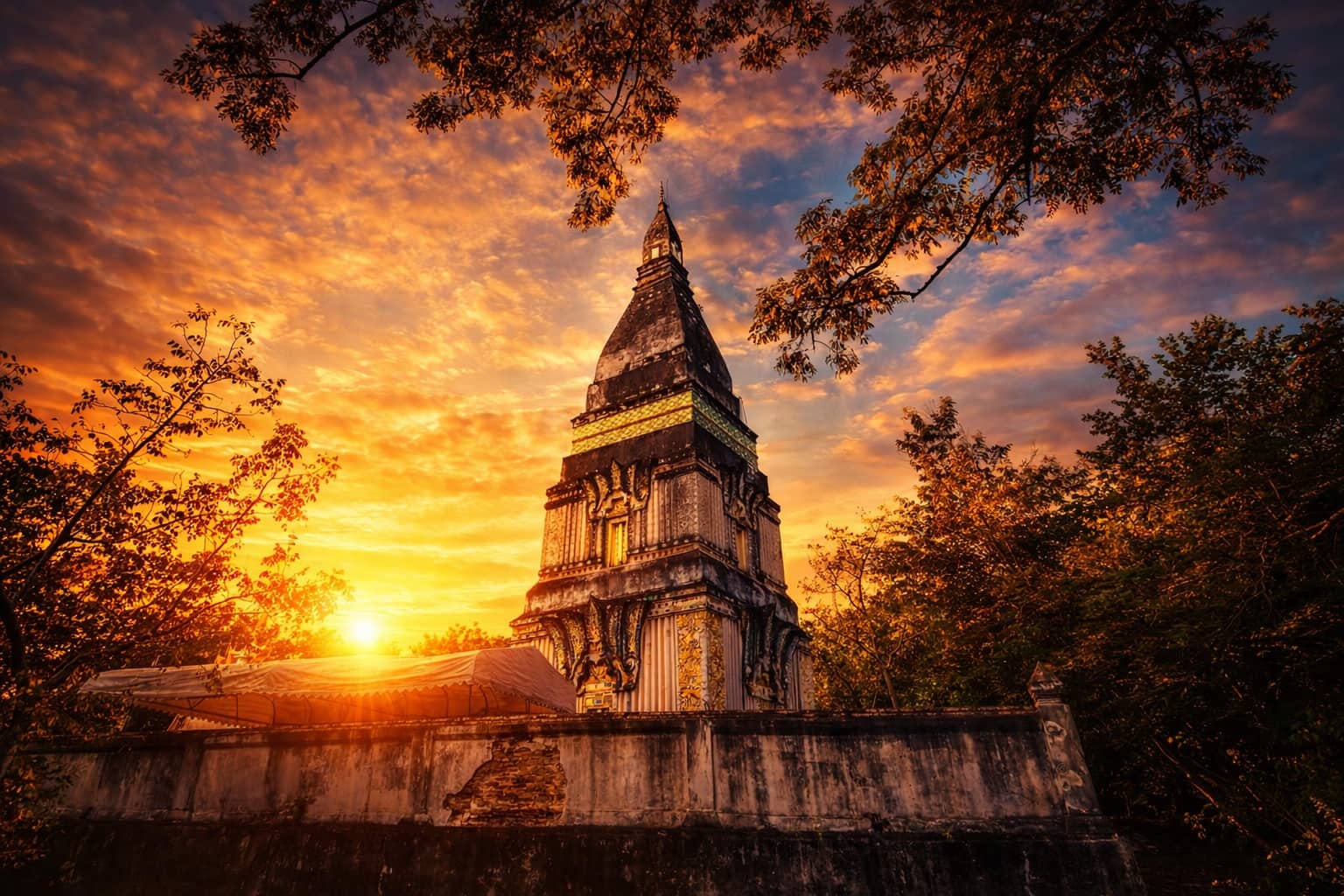 Golden Phra Phutthabat Bua Bok chedi at sunrise in Udon Thani UNESCO park